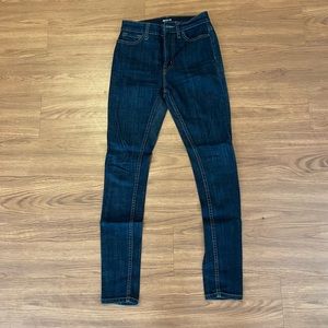 BDG dark blue super skinny jeans with red contrast stitching. Size 24.